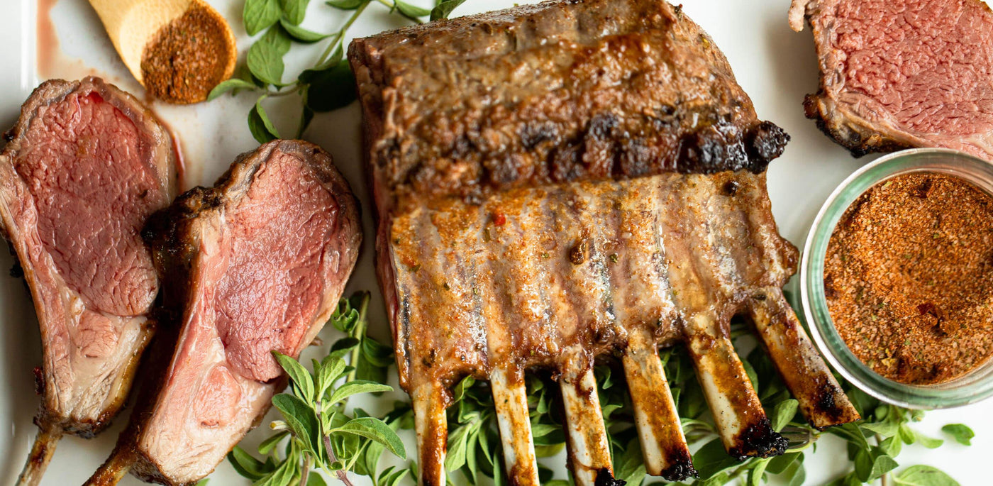 Tender roasted Rack of Lamb made with rack of lamb, olive oil, and seasoning salt presented with fresh thyme leaves.